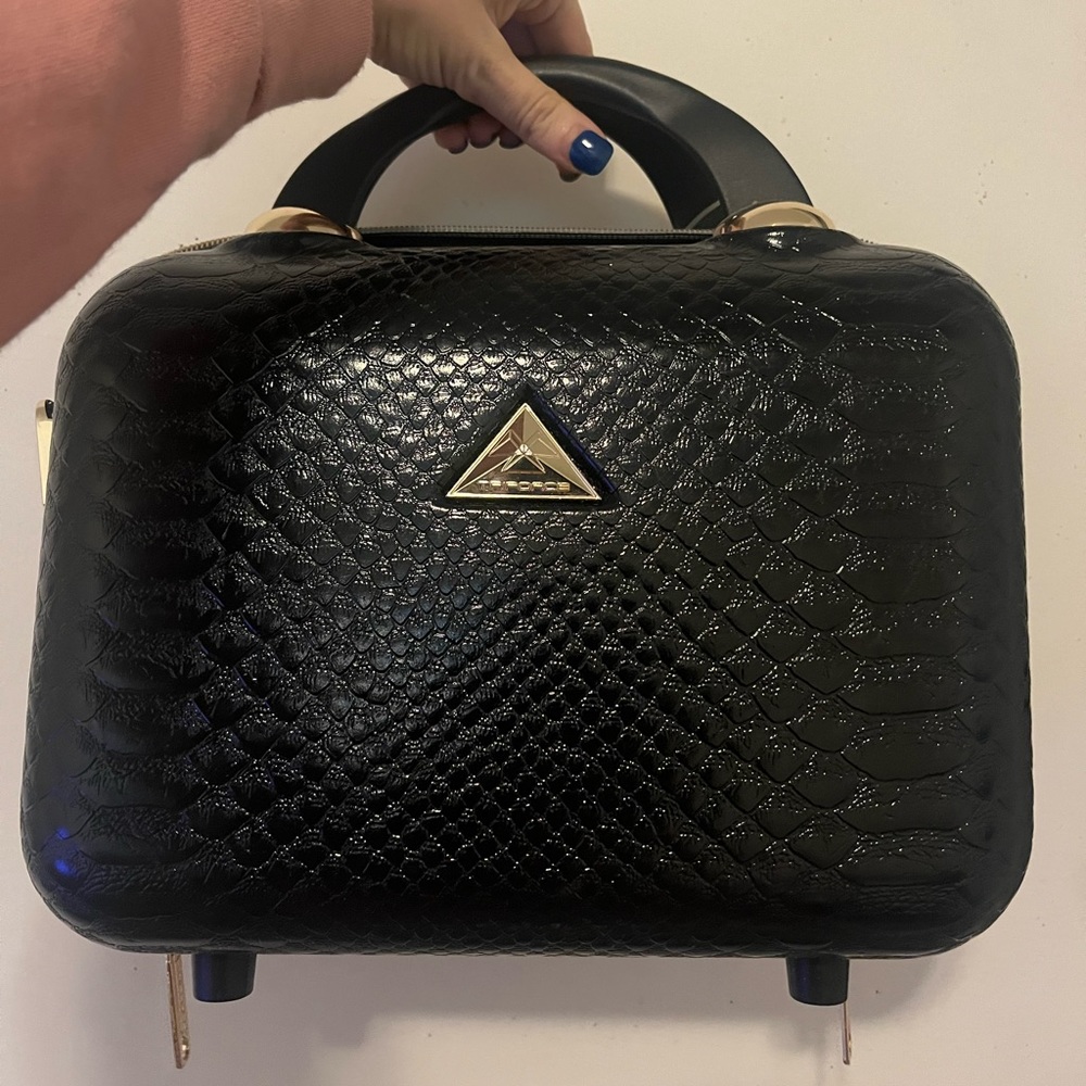 Triforce brand travel ware. Black, hard shell travel bag with detachable strap